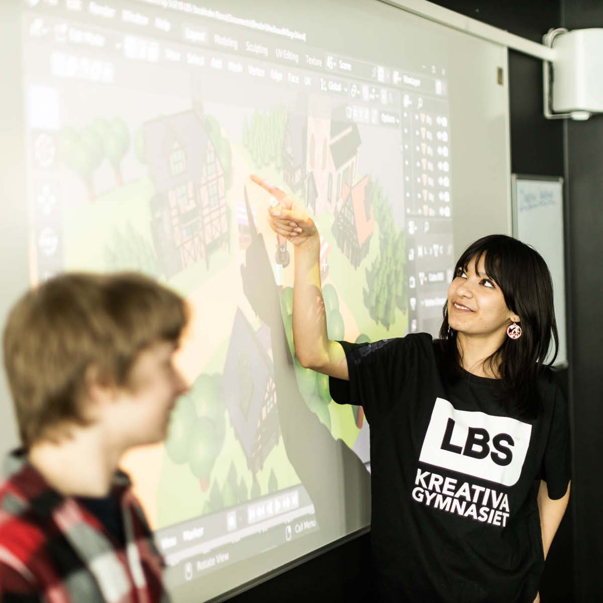 Elever presenterar deras arbete inför klassen på storbildskärm.